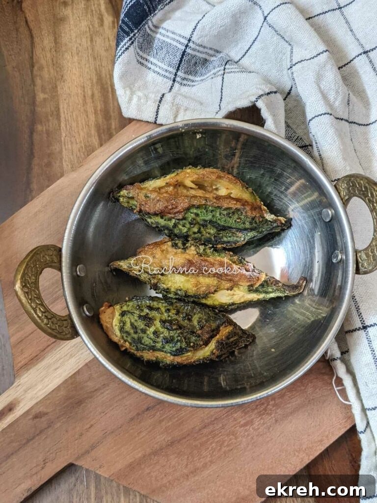 3 air fried karelas kept in a wok.