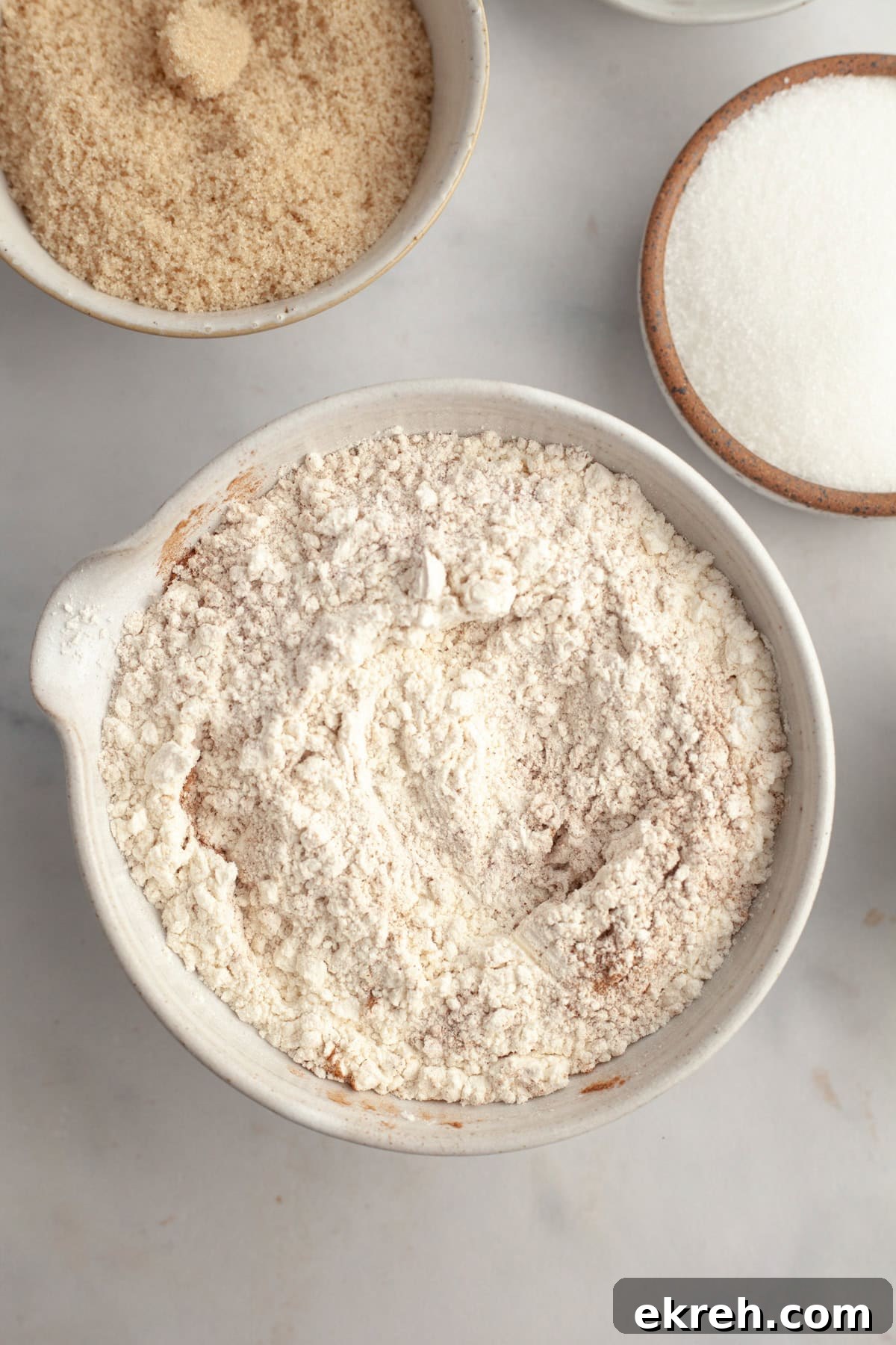 Flour and cinnamon mixed together in a bowl.