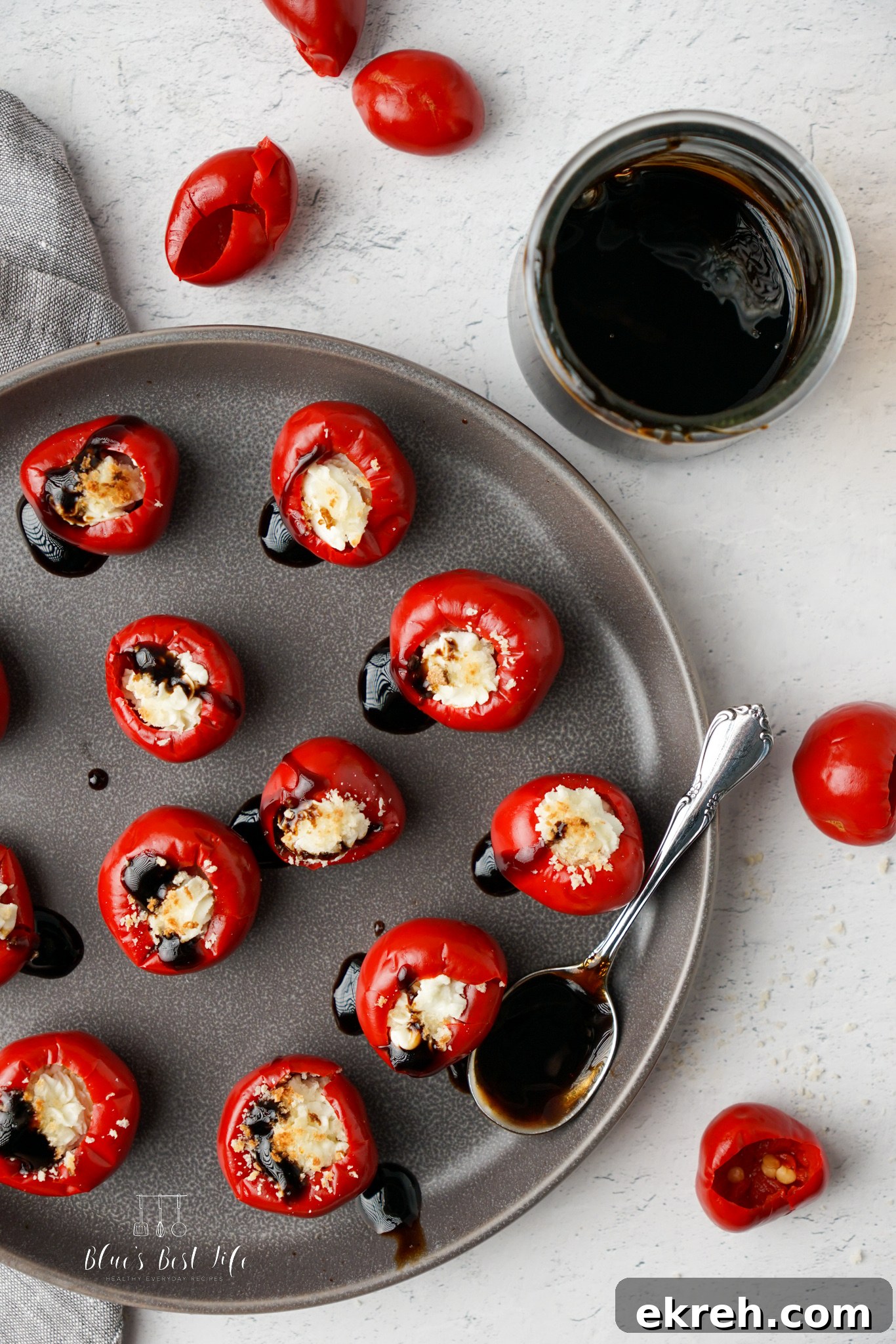 A plate with peppadew peppers stuffed with goat cheese. 