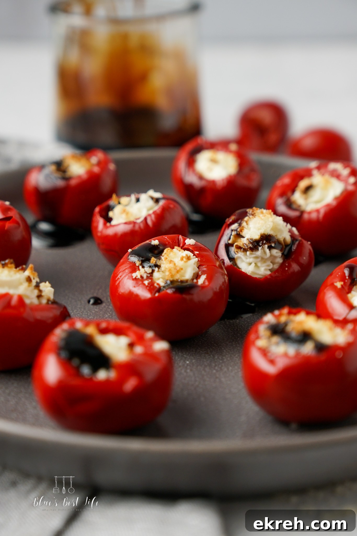 A close up of goat cheese stuffed peppadews. 