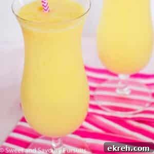 Tropical Pineapple Mango Smoothie Recipe 3 Two glasses of pineapple mango smoothie.