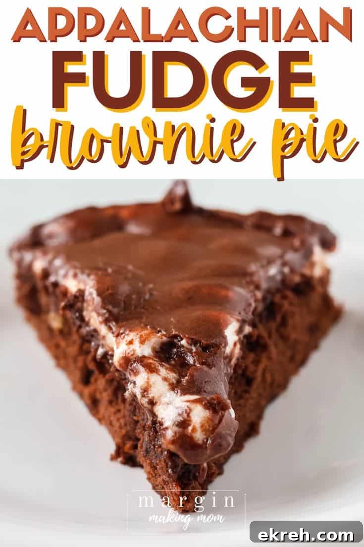 Classic Appalachian Fudge Brownie Pie Recipe 2 close-up view of a slice of Appalachian fudge brownie pie, showing the brownie base, melty marshmallow layer, and chocolate frosting on top.