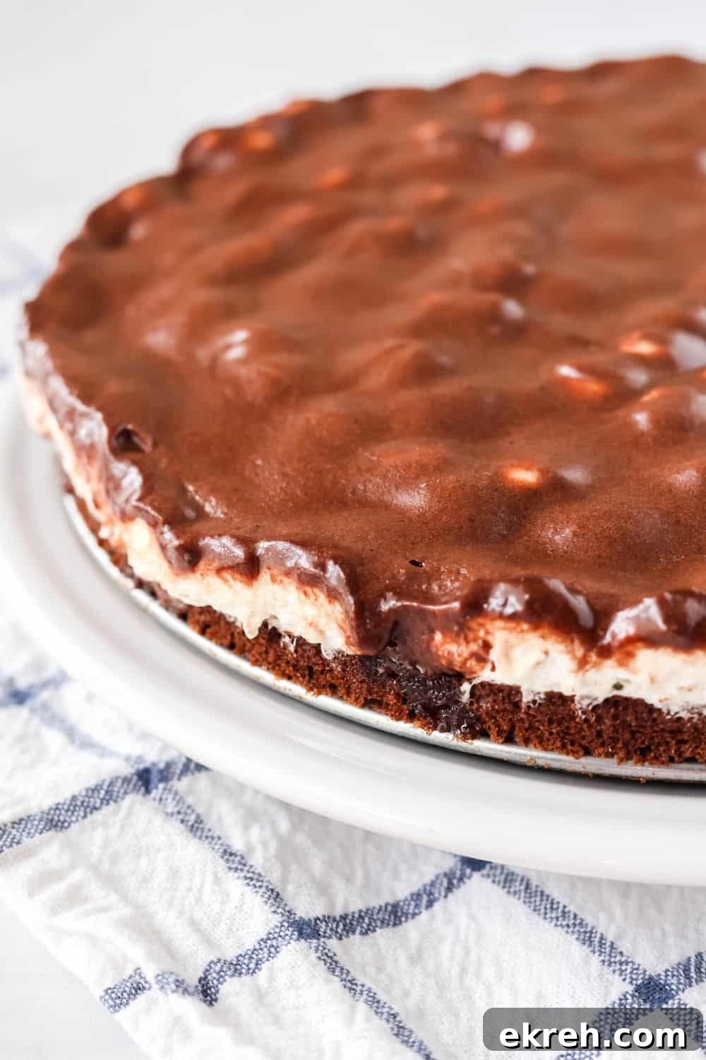 Classic Appalachian Fudge Brownie Pie Recipe 3 view of the side of a fudge brownie pie, including the brownie, marshmallow, and frosting layers.