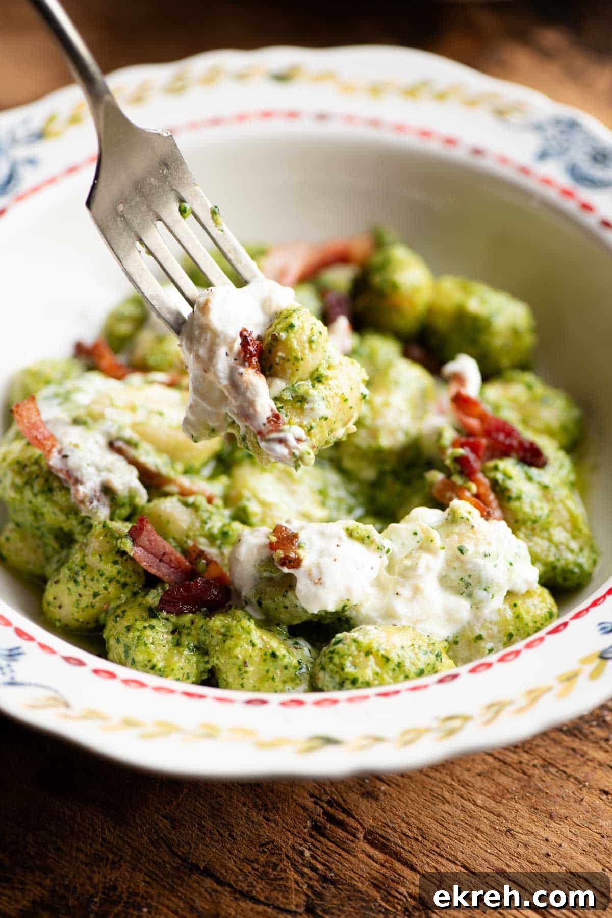 Arugula Pesto Gnocchi with Creamy Burrata and Crispy Pancetta 6 A close up of a fork picking up some arugula pesto gnocchi.