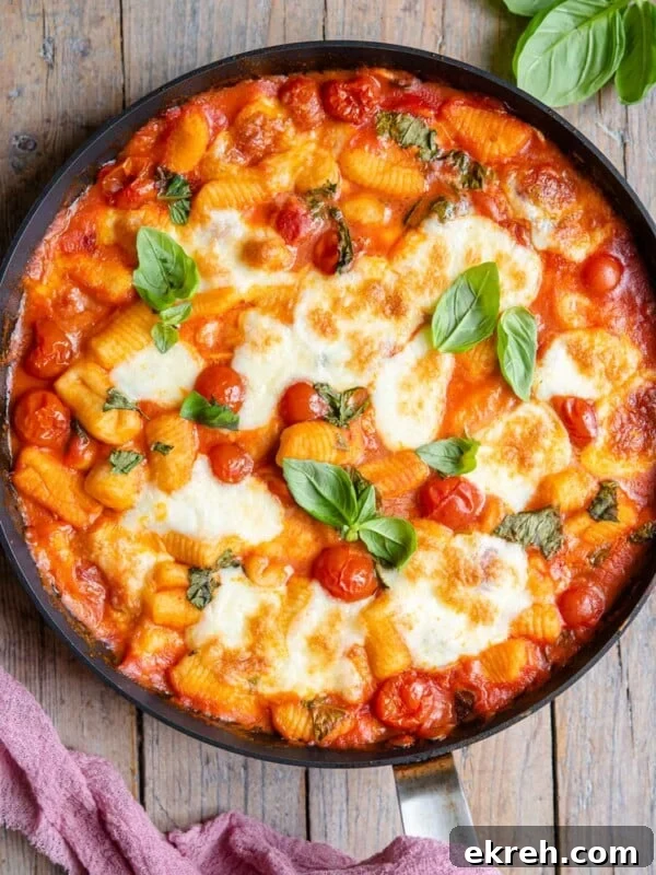 Arugula Pesto Gnocchi with Creamy Burrata and Crispy Pancetta 7 An overhead shot of baked gnocchi in a skillet