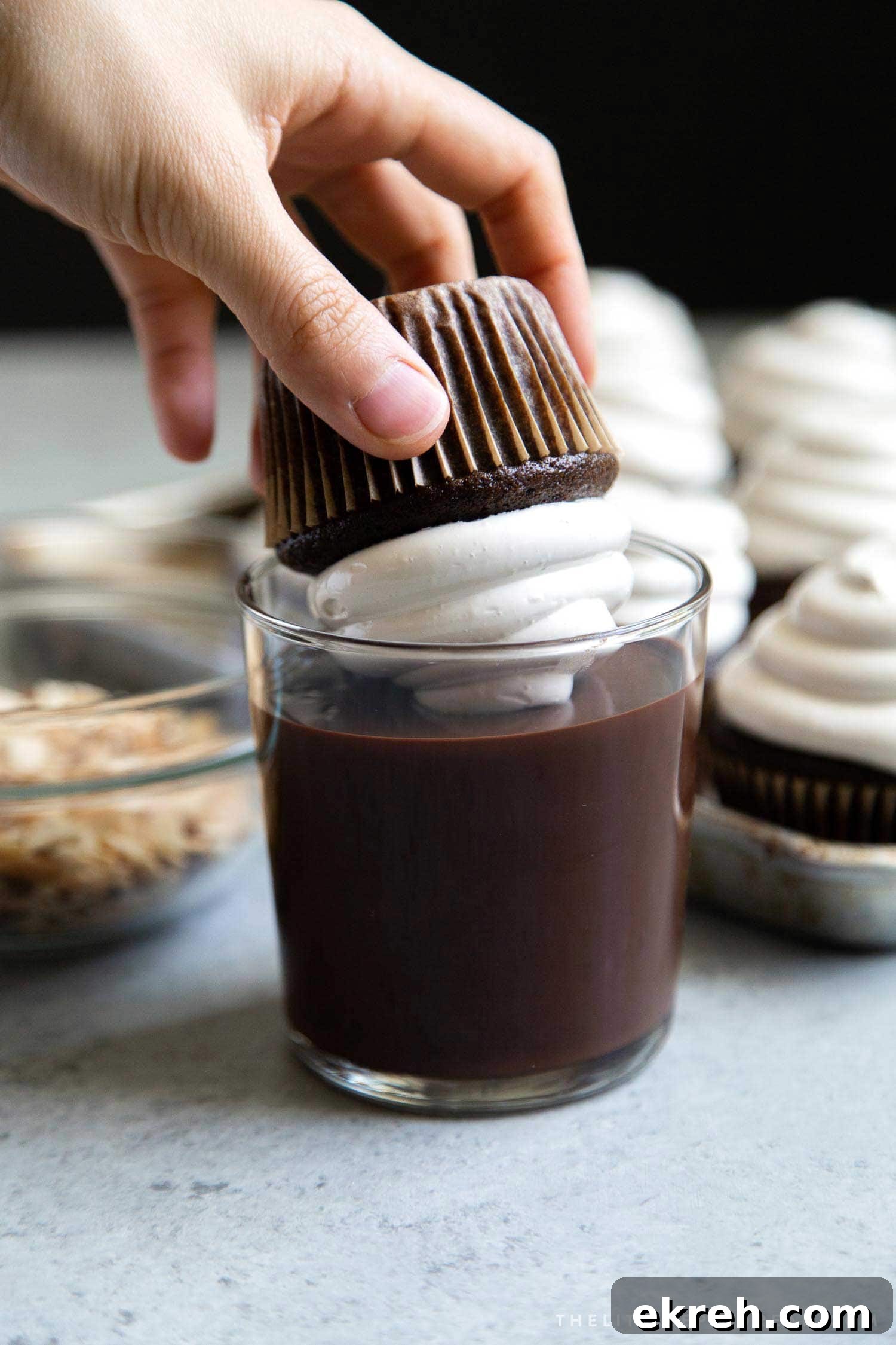 Almond Mocha Hi-Hat Cupcakes. Espresso meringue topped chocolate cupcakes dipped in melted chocolate.
