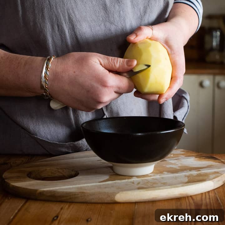 How to Make a Traditional Cornish Pasty (Authentic Recipe) 6 womans hands chipping a raw potato for making a pasty