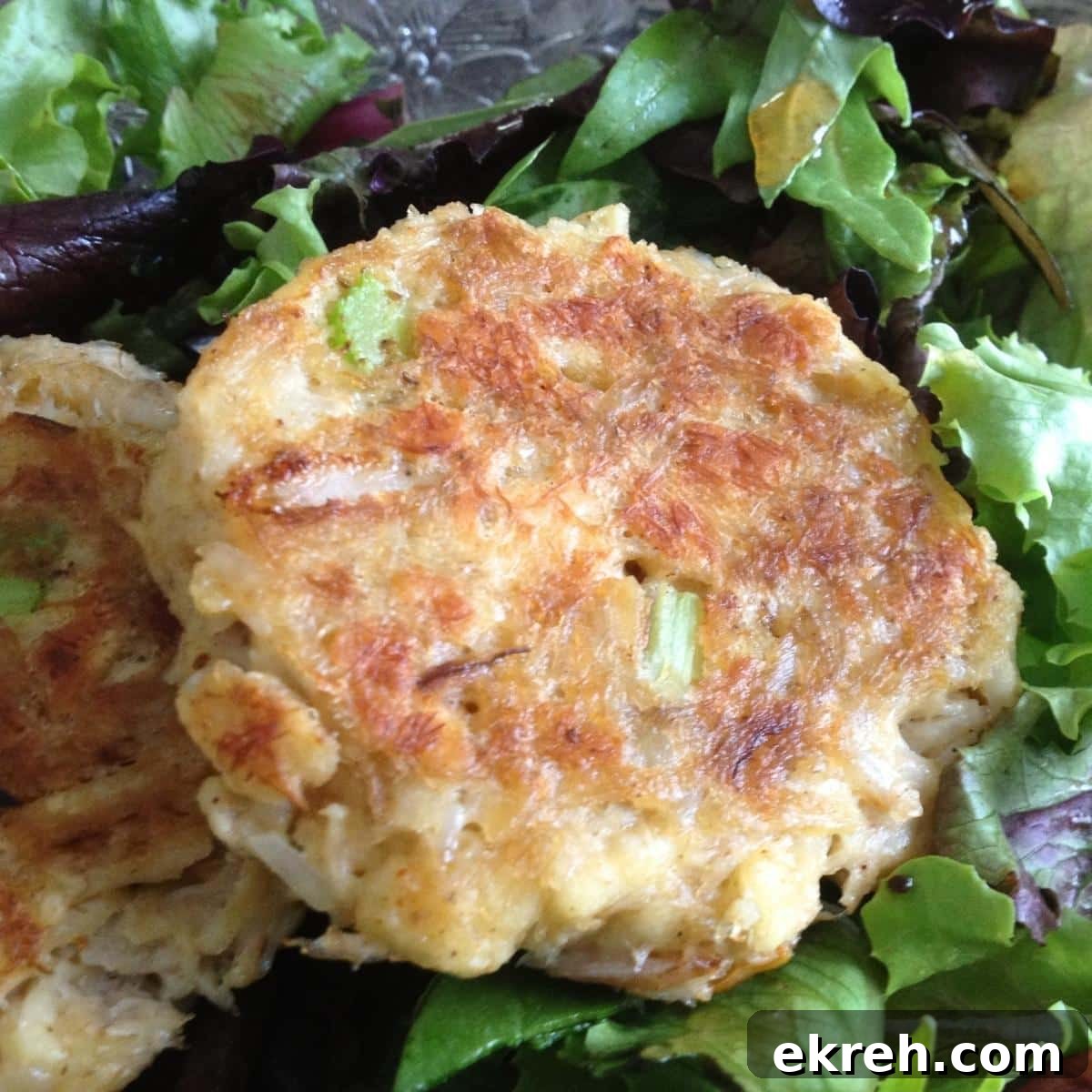 Maryland-style lump crab cake made without eggs on a bed of salad greens.