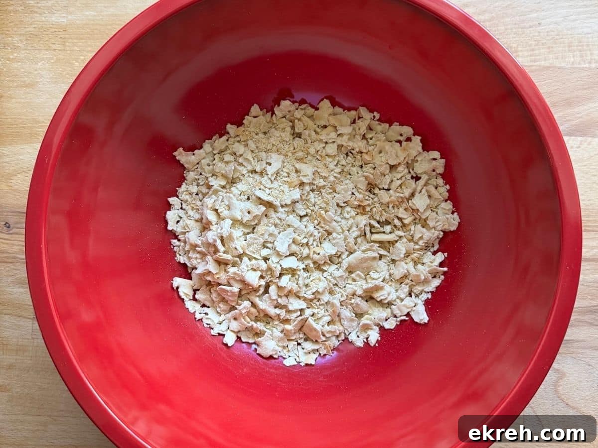 Crushed saltines in a red bowl.