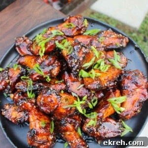 A plate full of Hot Honey Garlic Wings that are garnished and served.