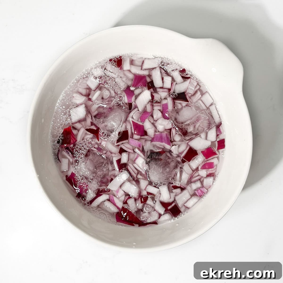 Tangy Indian Onion Chutney Recipe for Poppadoms 5 Chopped onions soaking in a bowl of ice water.