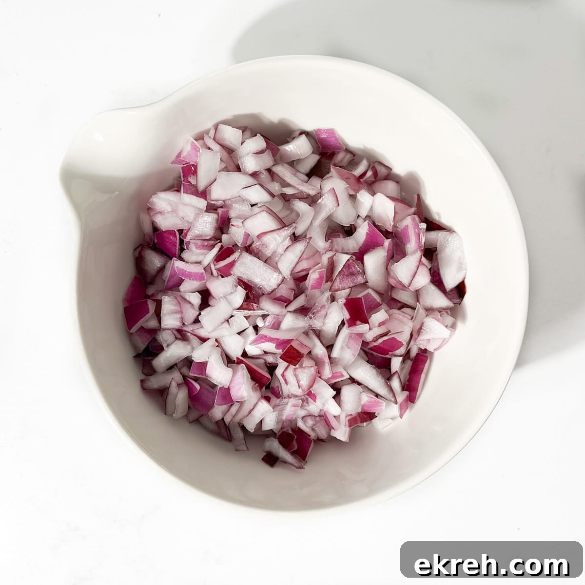 Tangy Indian Onion Chutney Recipe for Poppadoms 9 Soaked and dried onions in a white bowl.