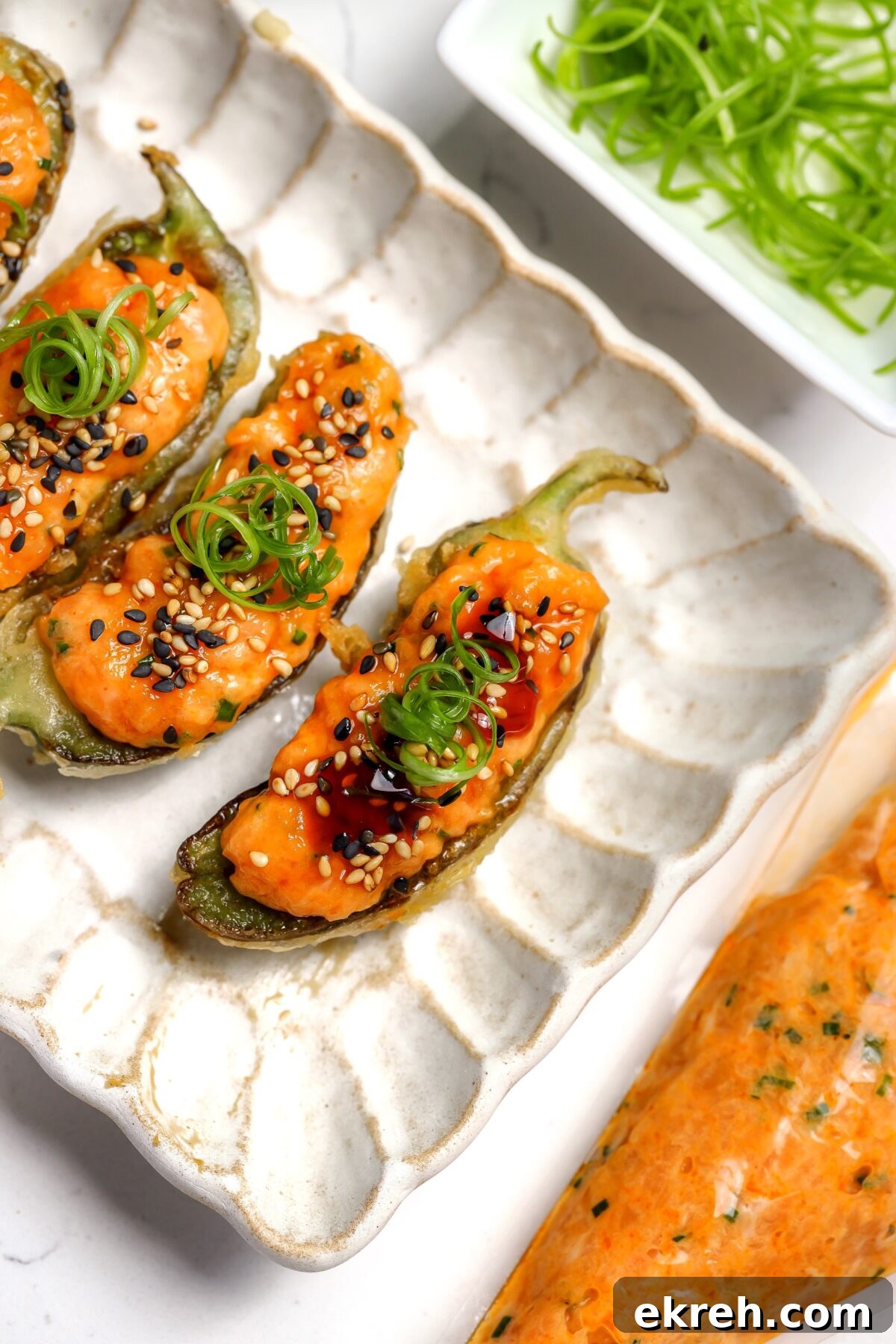 Crispy Salmon Tempura Jalapeno Bites Recipe 2 A tempura coated jalapéno with spicy salmon and eel sauce inside.