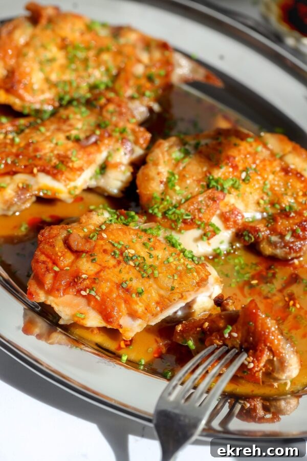 Crispy chicken thighs seared and coated in a sake butter sauce.