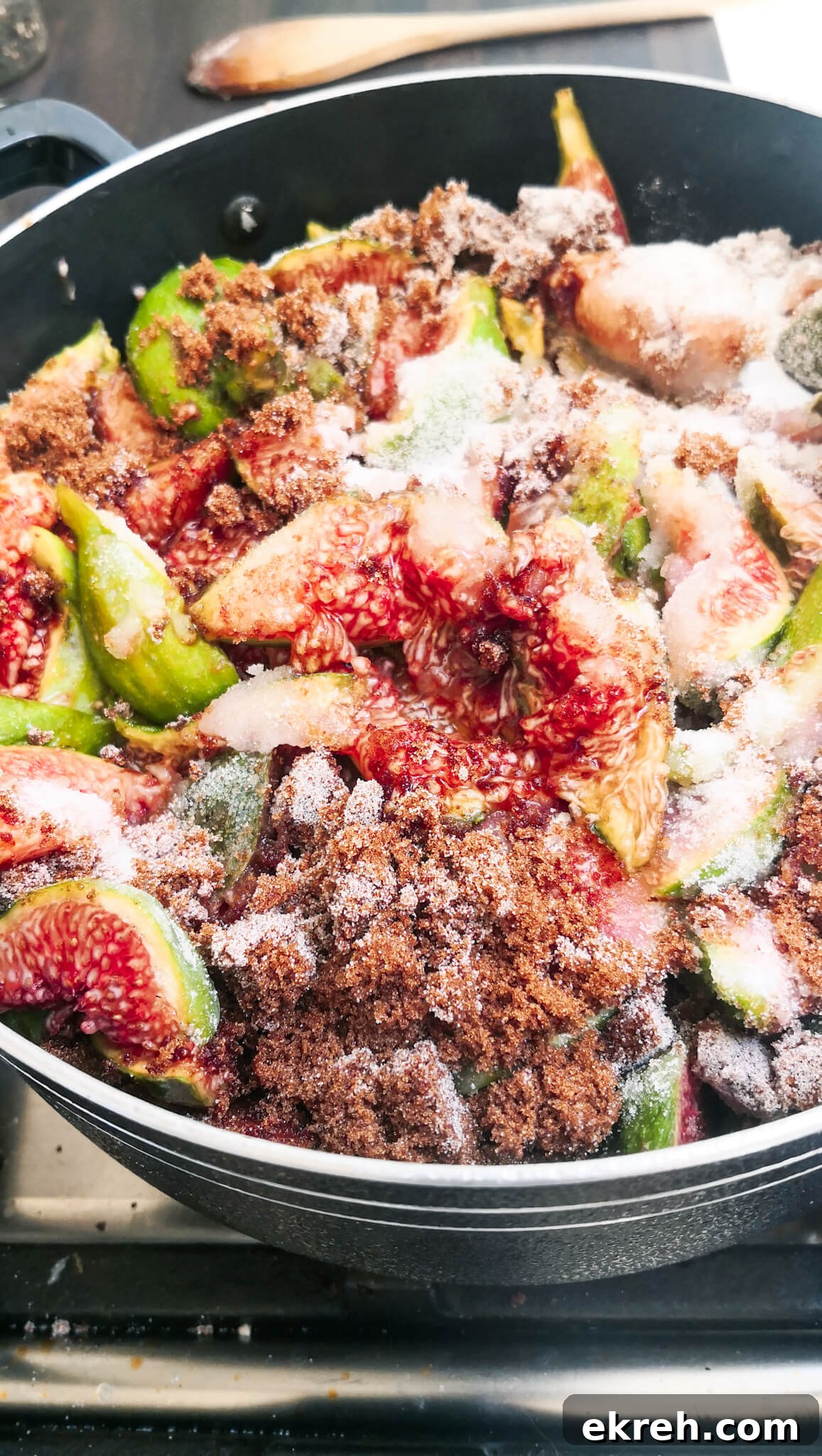 Fig chutney ingredients combined in a large black pot.