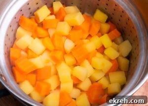 Chopped Carrot and Swede in sieve, drained off water