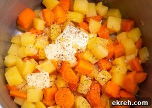 Carrot and Swede,butter salt and pepper on top in a large pot