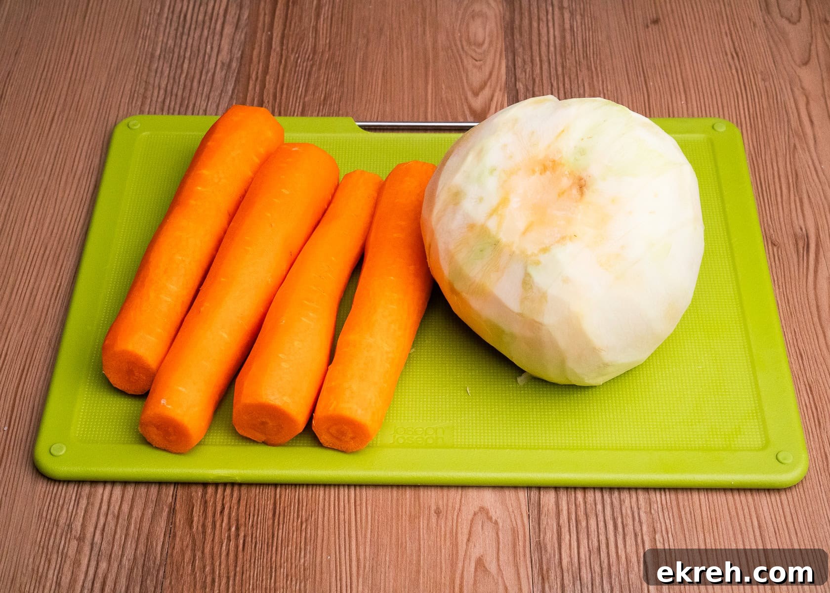 Four carrots,one swede on a green chopping board
