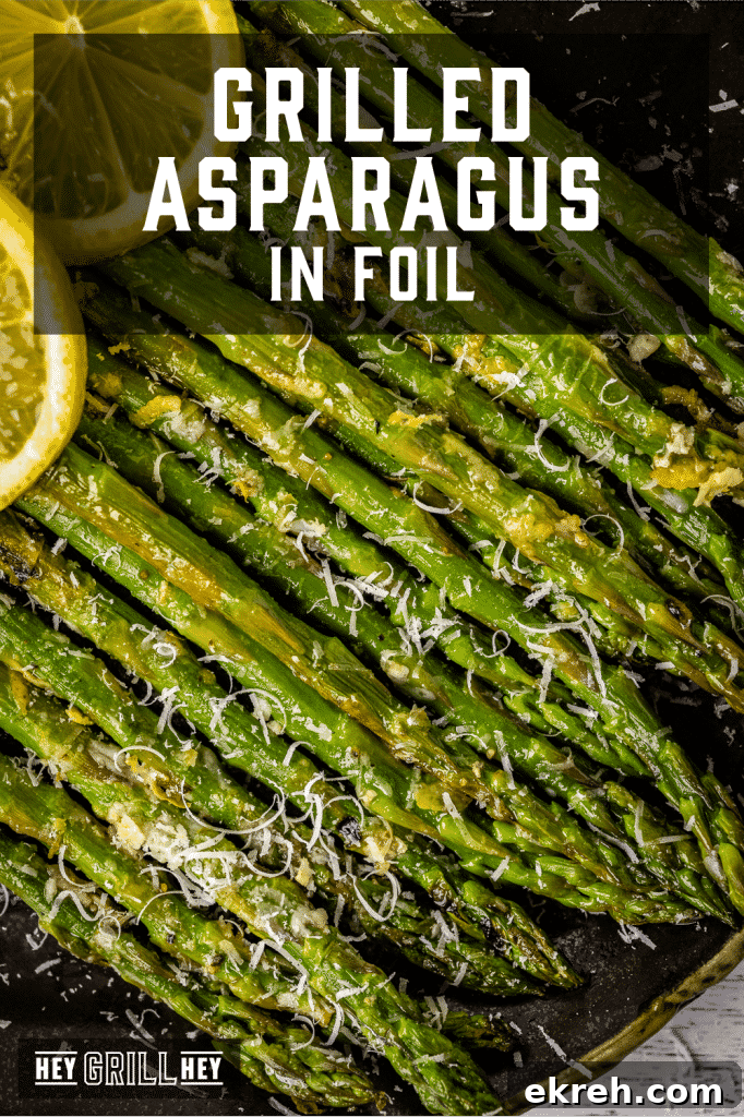 Stacked grilled asparagus topped with shredded parmesan cheese with text overlay - Grilled Asparagus in Foil.