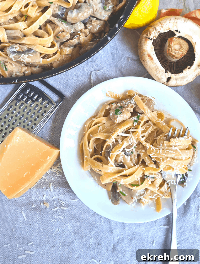 Finished creamy chicken mushroom pasta served with parmesan