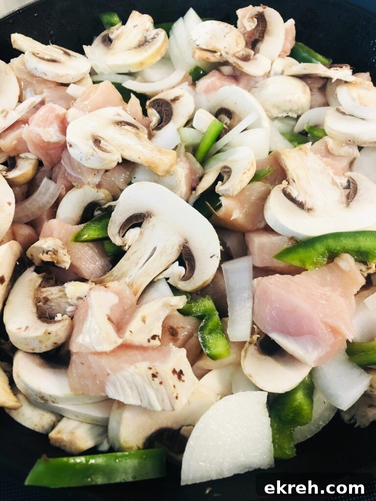 Air Fryer Philly Chicken Burritos Recipe 2 chicken philly filling in a skillet before cooking