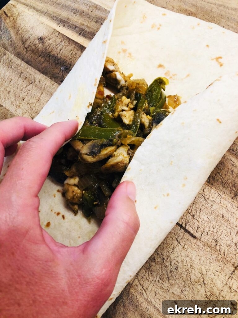 Air Fryer Philly Chicken Burritos Recipe 6 folding in the sides to roll the burrito