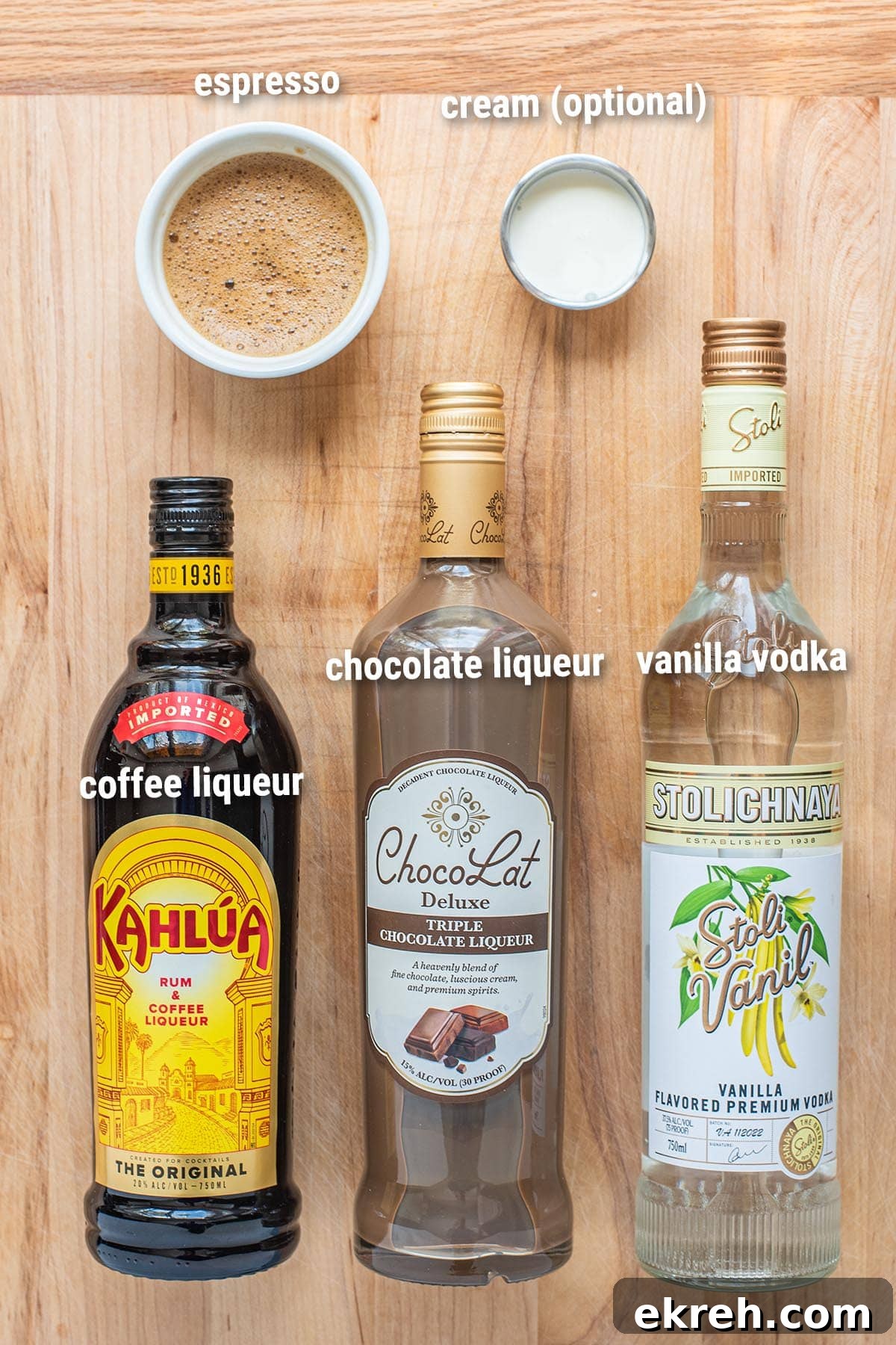 Chocolate espresso martini ingredients laid out on a wooden cutting board.