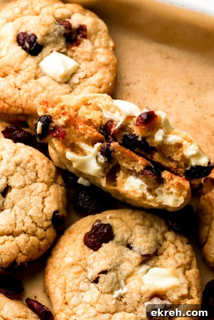 Chewy White Chocolate Cranberry Cookies 2 white chocolate cranberry cookies broken in half to show the inside
