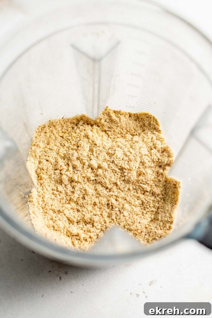 Blended vegan parmesan cheese in a blender.