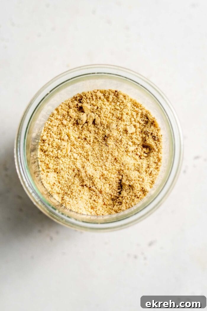 Vegan almond parmesan in a glass jar.