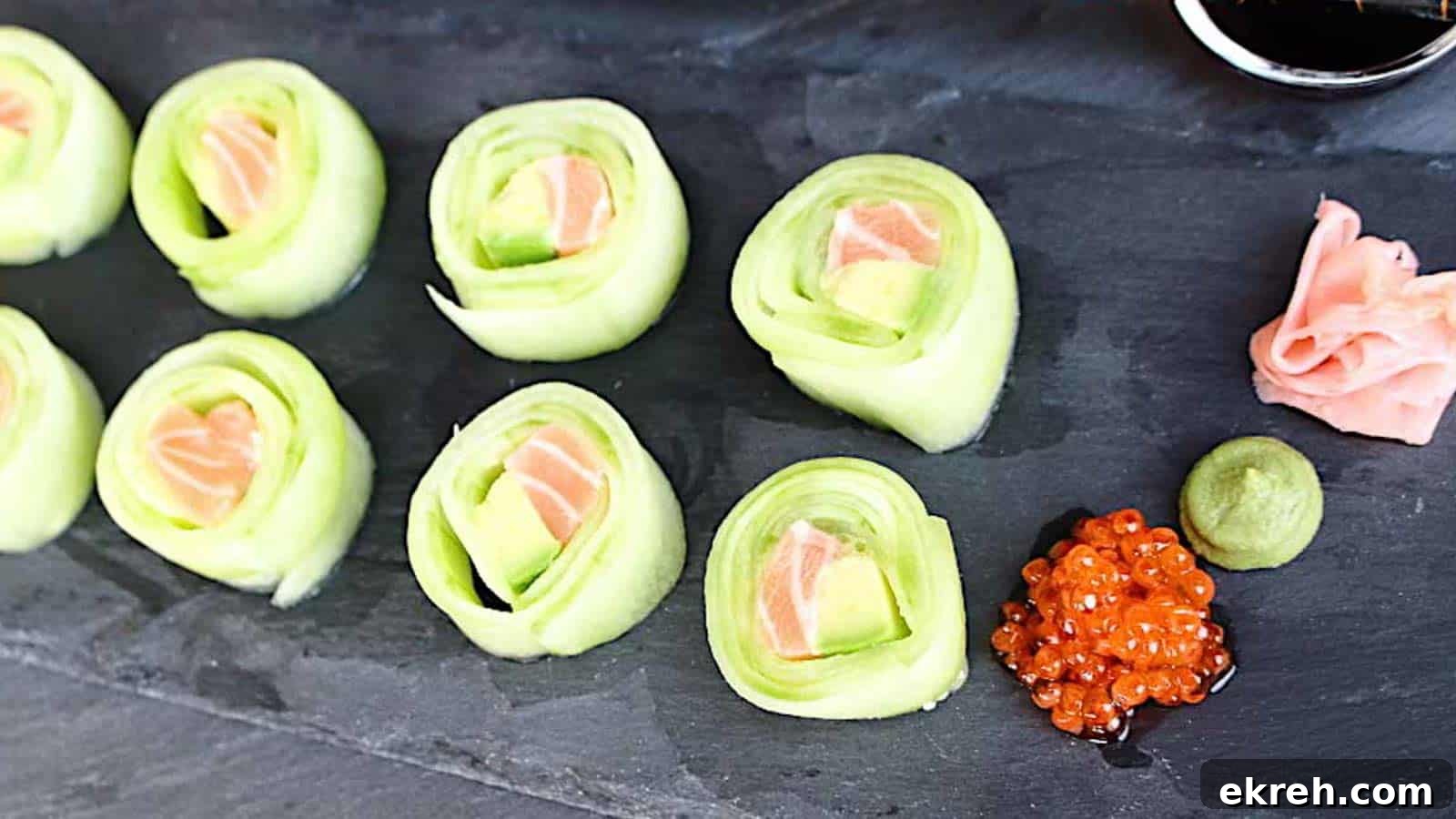 Cucumber Rolls on a black board.