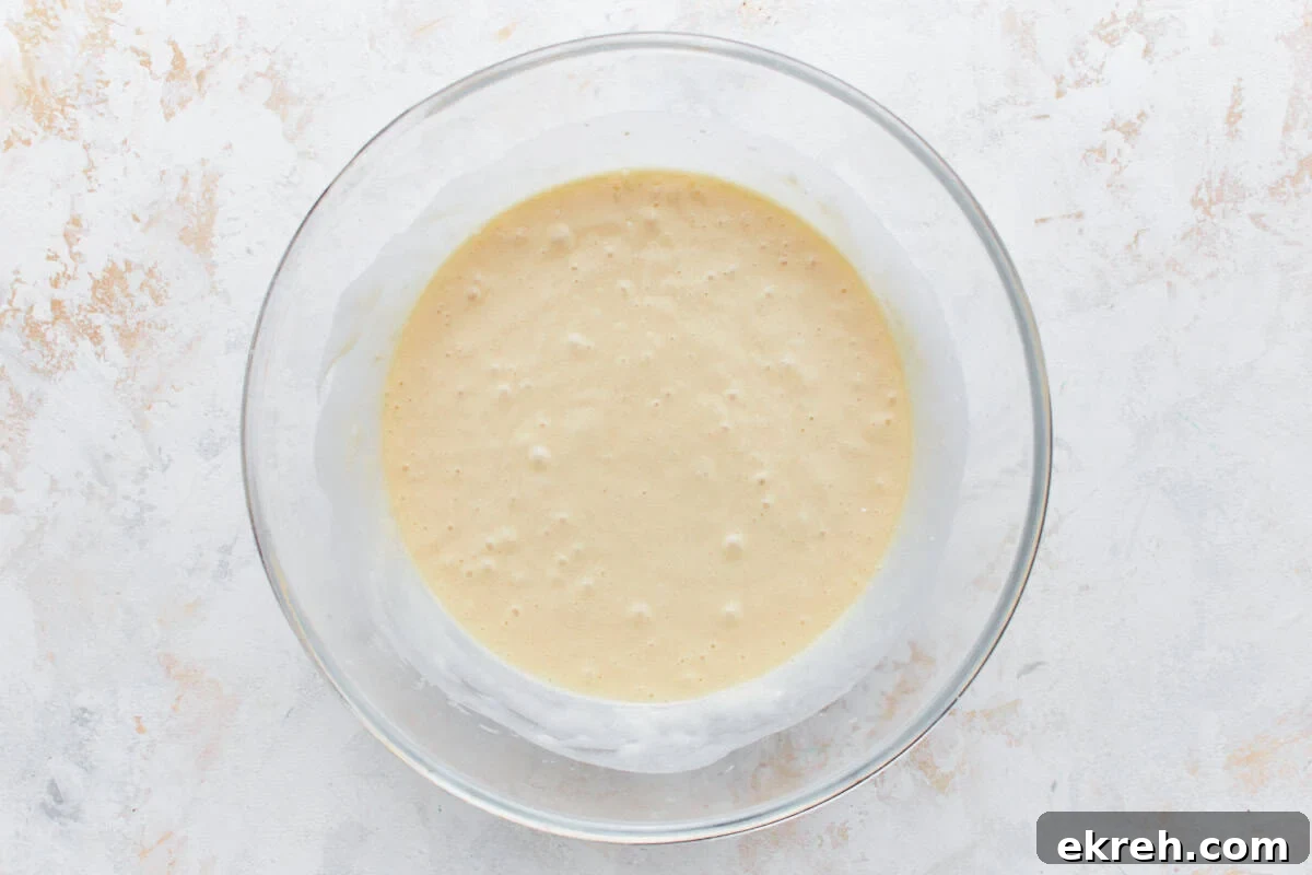 Cupcake batter in a glass mixing bowl.