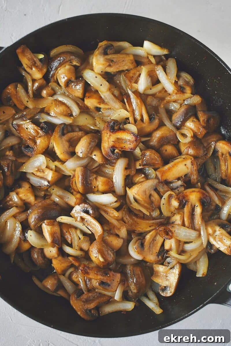 Garlic Butter Sauteed Mushrooms with Caramelized Onions 7 Mushrooms after the onions have been cooked in and everything is tender.