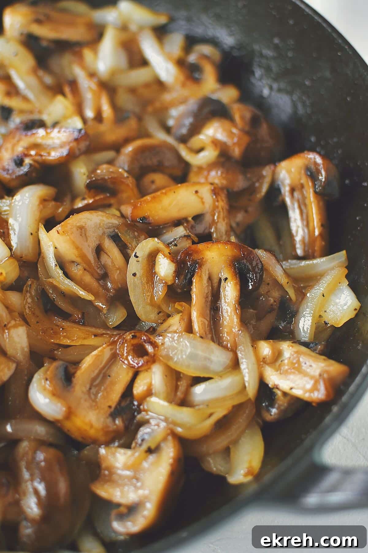 Garlic Butter Sauteed Mushrooms with Caramelized Onions 8 Sautéed Mushrooms and Onions, finished in the skillet, ready to be eaten.