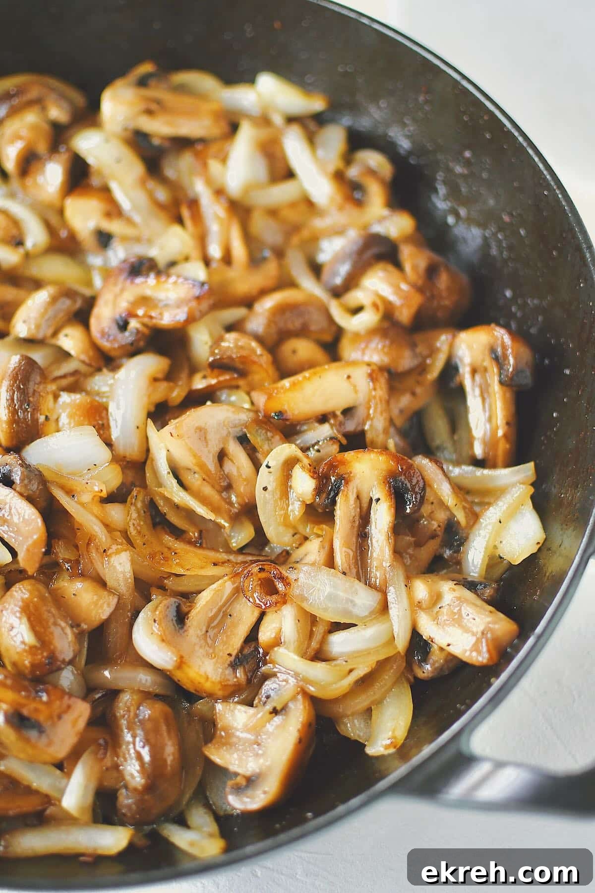 Garlic Butter Sauteed Mushrooms with Caramelized Onions 9 Sautéed Mushrooms and Onions, finished in the skillet, ready to be eaten.