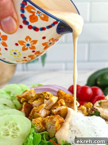 Tahini Sauce Recipe: Creamy Salad Dressing and Dips 13 Pouring tahini dressing on a salad.