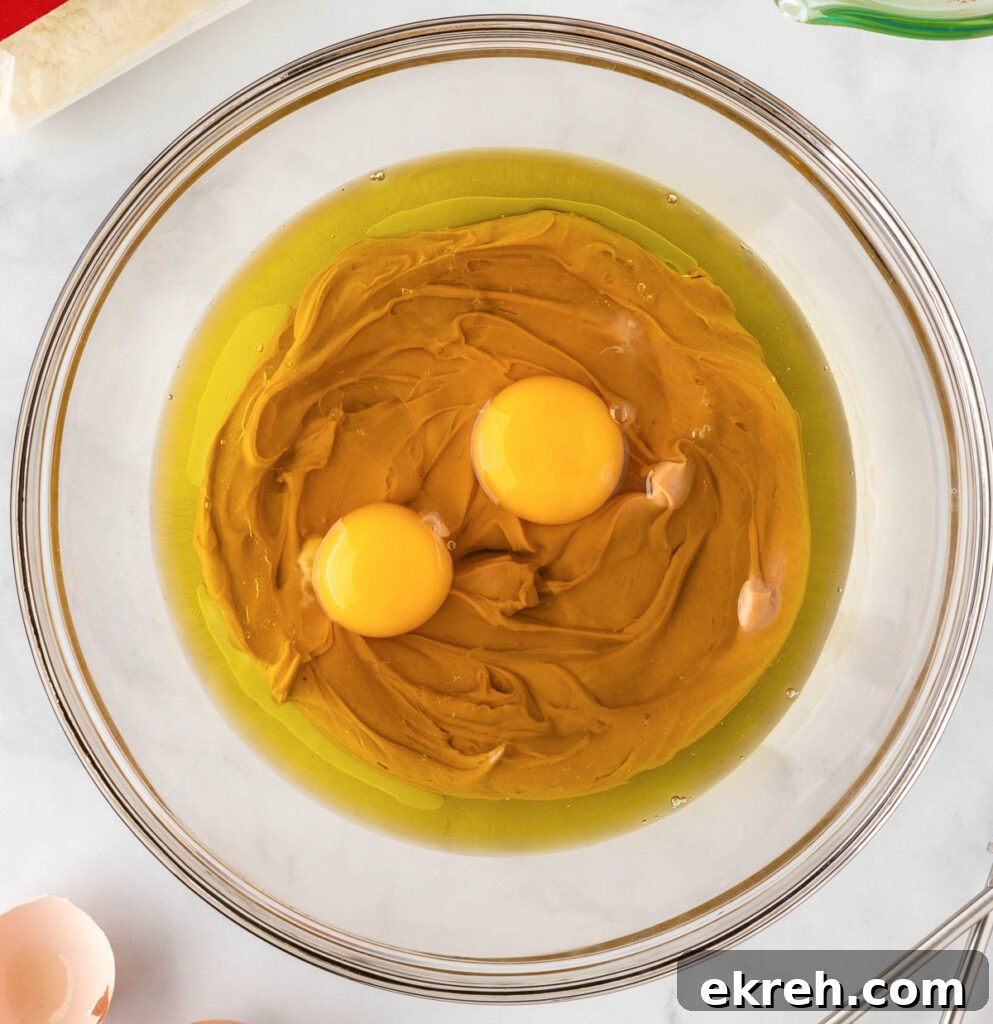 eggs, oil, and peanut butter in a mixing bowl