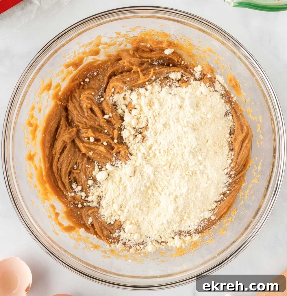 adding cake mix to the peanut butter batter