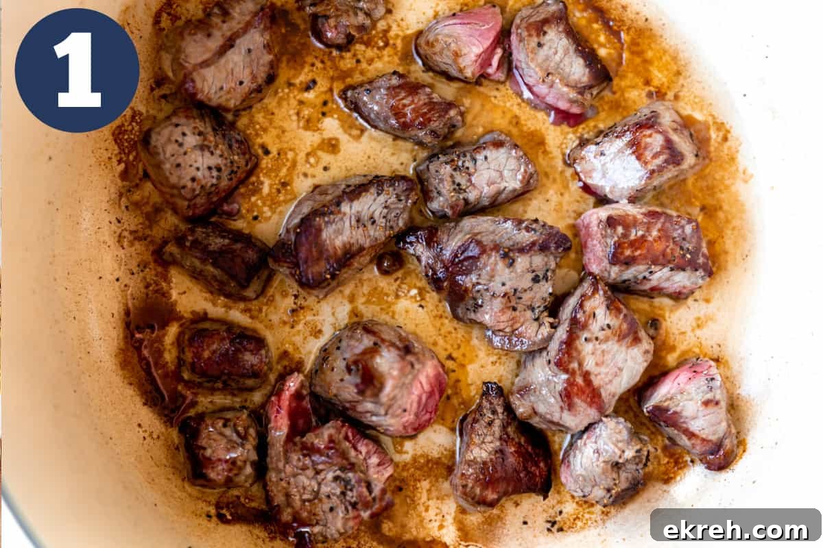 Searing stew meat in a dutch oven.