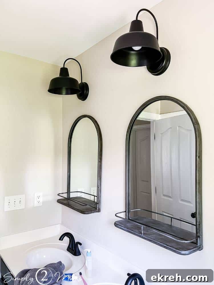 Simply Stated Episode 49: Actionable Insights 2 two mirrors with shelves with lights hung over them on wall above double bathroom sink vanity