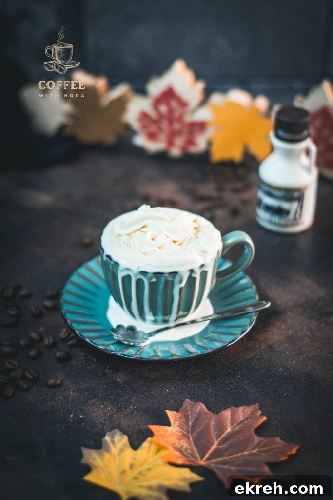 3-Ingredient Maple Whipped Cream Recipe 11 Blue coffee mug with coffee and maple syrup whipped cream topping. A little overflowing.