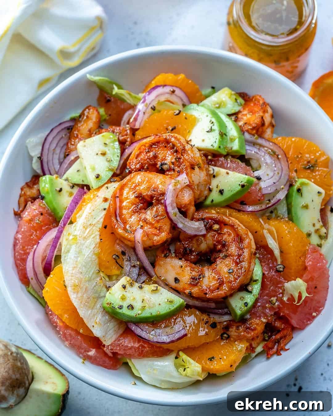 shrimp salad with grapefruit, oranges, and avocado in a bowl.