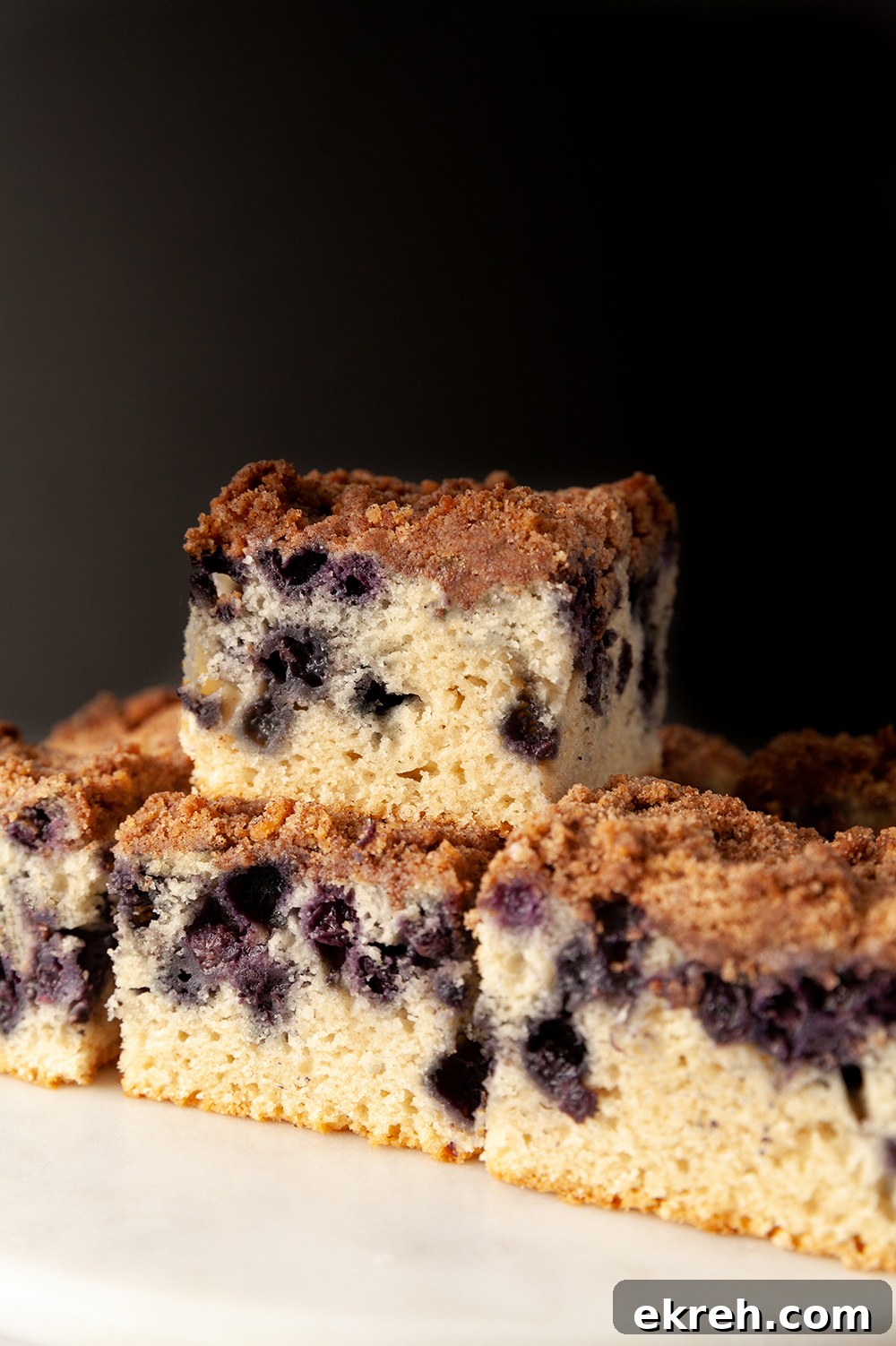 eggless lemon blueberry sheet cake against a black background 