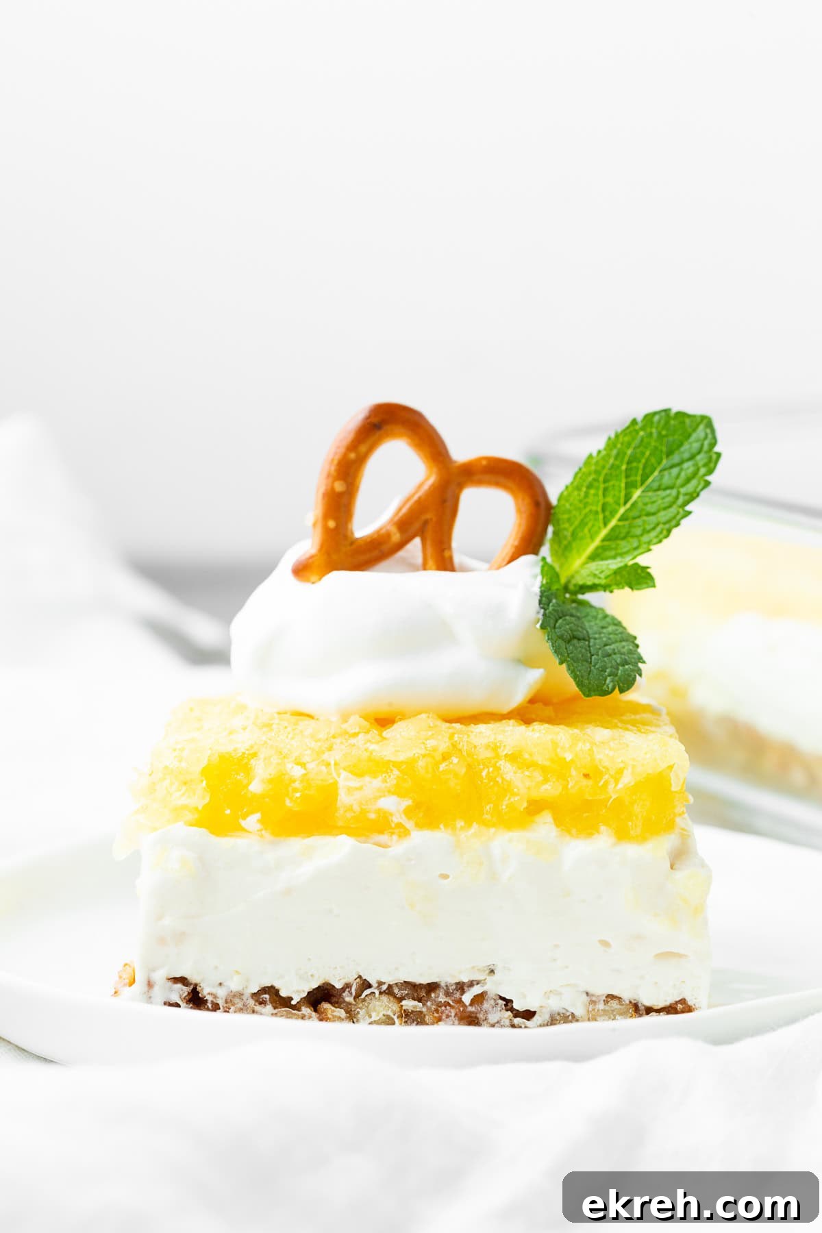 Pineapple Pretzel Salad topped with Cool Whip.