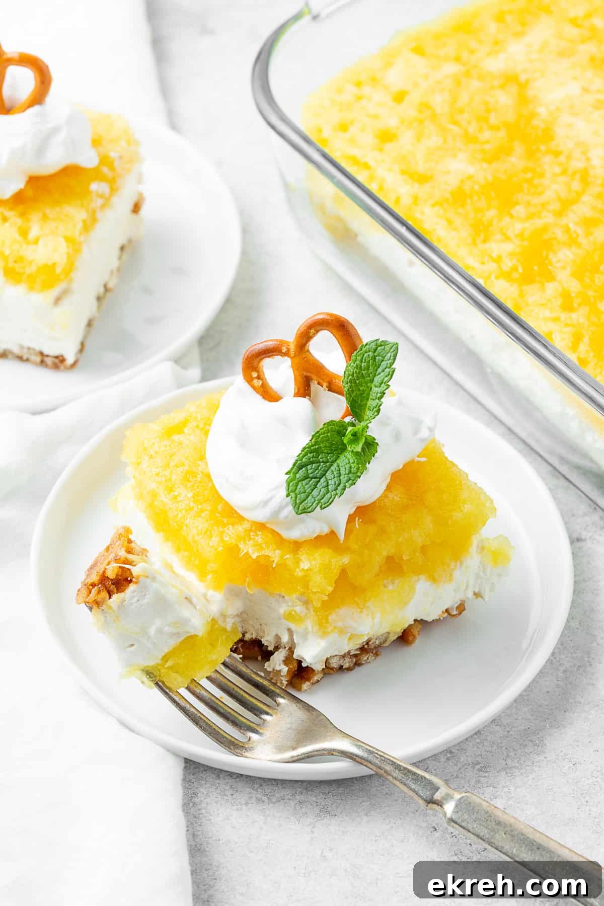Pineapple Pretzel Salad on a plate with a fork.