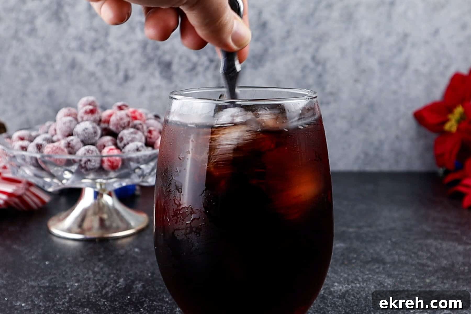 Quick Christmas Cocktail Recipe 8 Stirring the Christmas drink after all ingredients have been added.