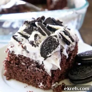 A slice of Oreo poke cake on a plate.