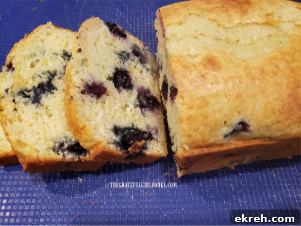 Slices of the blueberry breakfast loaf reveal the juicy blueberries inside.