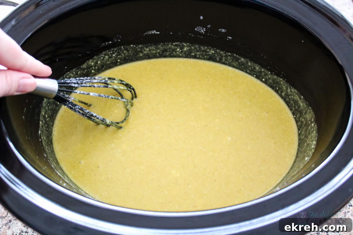 Fully mixed curry sauce and coconut milk in the slow cooker insert.