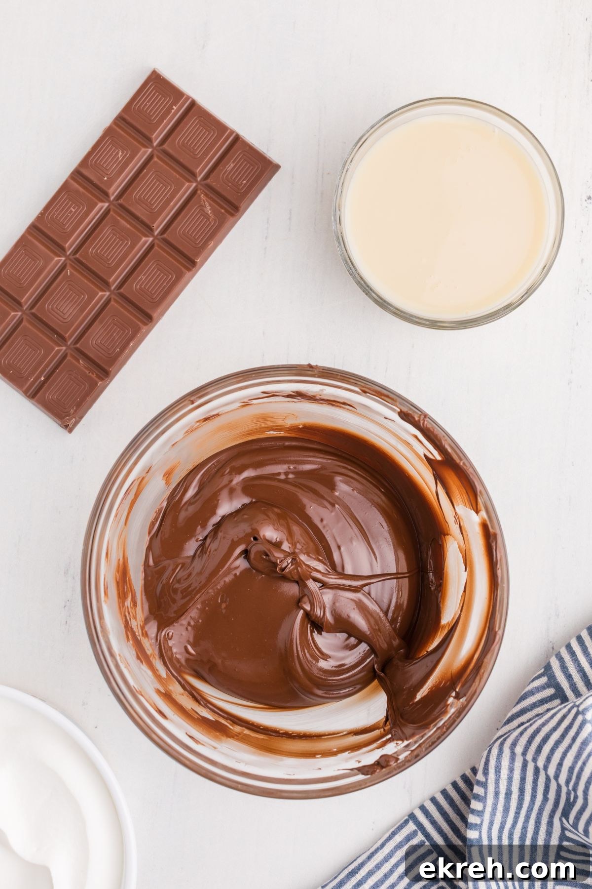Melted chocolate in a clear glass bowl. 